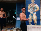 Weight Lifter Flexes at Facility Inside Cao Dai Temple Complex  Tay Ninh  Vietnam