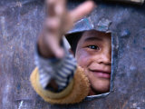Boy Reaching through Hole in Gate  Alchi  Jammu and Kashmir  India