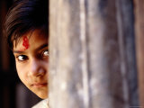Girl with Forehead Marking Peering from Behind Pillar  Rajasthan  India