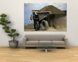 A Dump Truck Carrying Gravel Kicks up a Cloud of Dust