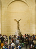 Interior of The Louvre Museum Showing Winged Victory Statue and Tourists  Paris  France