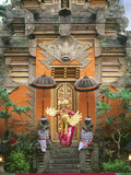 Balinese Dancer Wearing Traditional Garb Near Palace Doors in Ubud  Bali  Indonesia