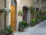 Flower Pots and Potted Plants Decorate a Narrow Street in Tuscan Village  Pienza  Italy