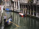 Gondola with Passengers on a Canal  Venice  Italy