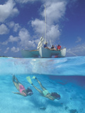 Two Women Snorkeling and People on a Sailboat