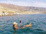 Woman Floating in the Dead Sea Reading a Magazine  Aqaba  Jordan