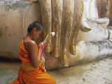 Novice Buddhist Monk and Phra Atchana Buddha Statue  Sukhothai Province  Thailand