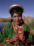 Head and Shoulders Portrait of a Uros Indian Woman Holding Pipes  Lake Titicaca  Peru