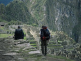Backpackers Look at the Inca Ruins at Machu Picchu  Unesco World Heritage Site  Peru  South America