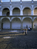 Girls in Local Clothing Carry Crafts on Heads  Main Plaza  Antigua  Guatemala  Central America