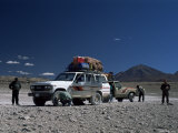 Landcruisers and Tourists on Jeep Tour Taking a Break on Uyuni Salt Flat  Bolivia  South America