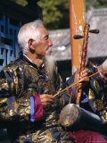 Portrait of an Elderly Musician from the Naxi Orchestra Practising by the Black Dragon Pool  China