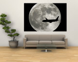 A Jet Plane Passes in Front of the Full Moon Above Surfside  Fla