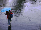 Elevated View of a Student in the Rain with a Blue Umbrella