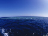 Coral Reef Seen from above the Water with Seascape on the Horizon
