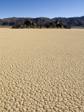 Dry Desert Lake Bed with Mountain Range in Background  California