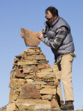 Man Builds a Rock Cairn on Topatopa Bluff in the Sespe Wilderness  California