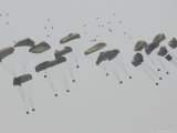 Paratrooper Supplies Coming Down under Parachutes