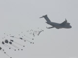 Paratrooper Supplies Deployed from the Back of C-140 Cargo Plane