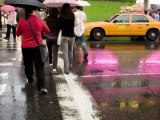 Pedestrians in a Times Square Crosswalk on a Rainy Afternoon