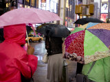 Pedestrians with Umbrella in Times Square on a Rainy Afternoon