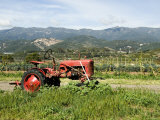 Red Tractor on Farm with Mountains in the Background  California