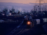 Trains Surrounded by Industrial Plants
