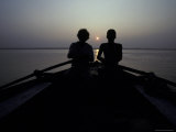 Silhouettes of Boatmen Rowing at Dawn on the Holy Ganges River