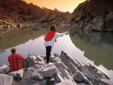 Two People Fish into a Small River in Maryland