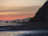 Silhouetted People Walking at Sunset on California Beach