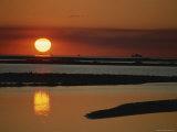 Silhouettes of Shell Dredges on the Horizon at Sunset
