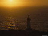 The Yaquina Head Lighthouse is Silhouetted by the Sunset  Oregon