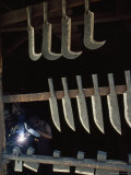 Tools Hang near a Metalworker at Work in a Saddle Maker's Shop