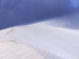 Winds Blast Across the Peak of a White Sand Dune  Wisping Away Sand  Australia
