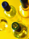 Three White Wine Bottles and a Wine Glass