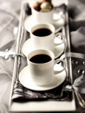 Arrangement of Two Cups of Coffee and Chocolates