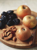 Apples  Prunes and Almonds on Wooden Board