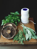 Mushrooms  Fresh Herbs & Kitchen String on Chopping Board