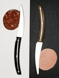 Two Knives  Each with a Slice of Sausage