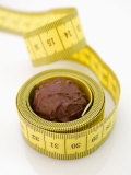 Chocolate Truffle Lying in Rolled-Up Tape Measure