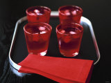 Water and Ice Cubes in Red Glasses on Tray