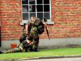 Soldiers of the Belgian Army Helping and Transporting a Wounded Mate