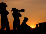 Three US Air Force Members Highlighted by the Setting Sun