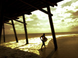 Surfer Walking along Tide