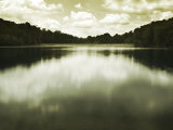 Water Reflecting Bordering Trees and Sky