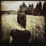Woman Following Trail in Field