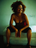 Woman Sitting on Bed  Smiling