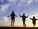 Silhouette of Children Jumping Rope Outdoors