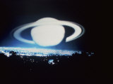Planet  with Rings  Over City and Trees at Night