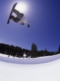 Airborne Snowboarder in Half Pipe Position
